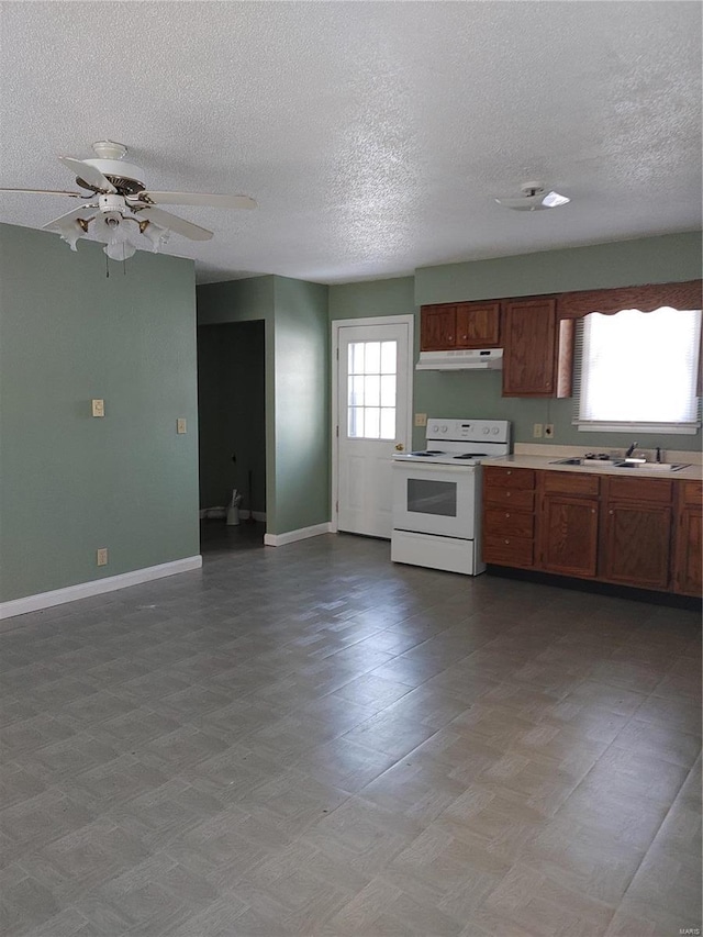 kitchen with a textured ceiling, electric range, ceiling fan, and sink