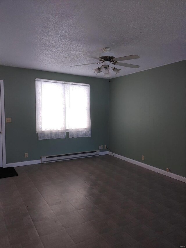 unfurnished room featuring ceiling fan and baseboard heating