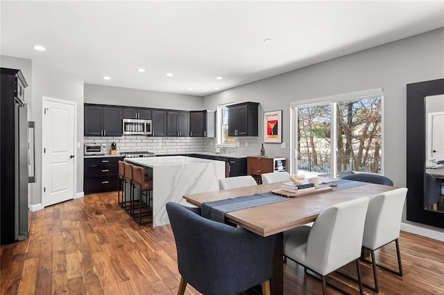 dining area featuring light wood-type flooring and sink