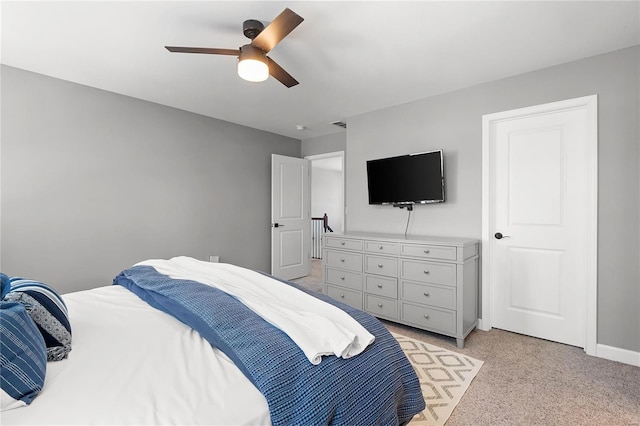 bedroom featuring light carpet and ceiling fan