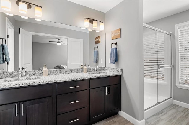 bathroom with ceiling fan, vanity, and walk in shower