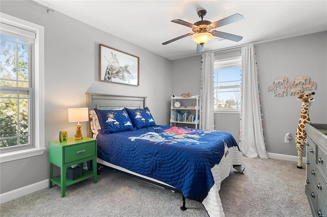 carpeted bedroom with multiple windows and ceiling fan