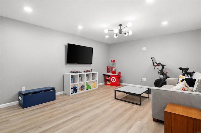 living room with light wood-type flooring and an inviting chandelier