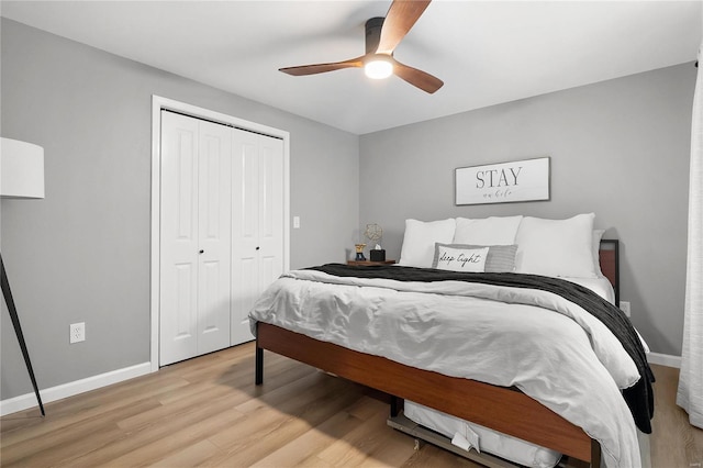 bedroom featuring ceiling fan, a closet, and light wood-type flooring