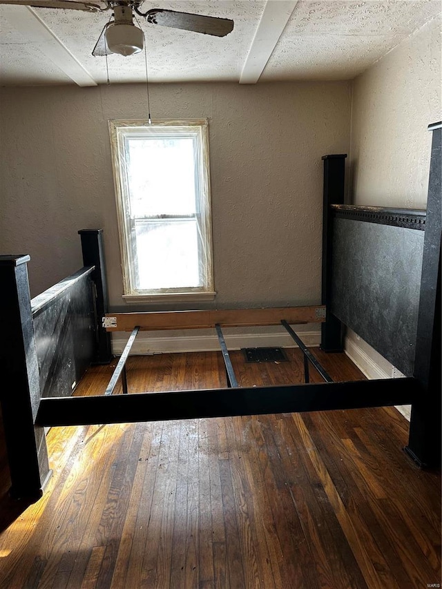 bedroom featuring ceiling fan and dark hardwood / wood-style flooring