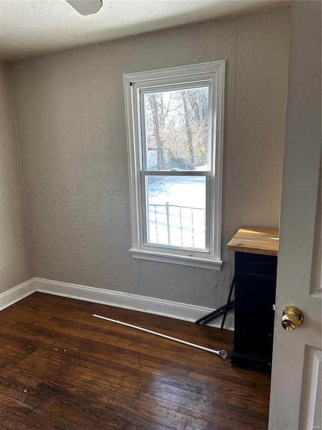 spare room featuring dark hardwood / wood-style flooring