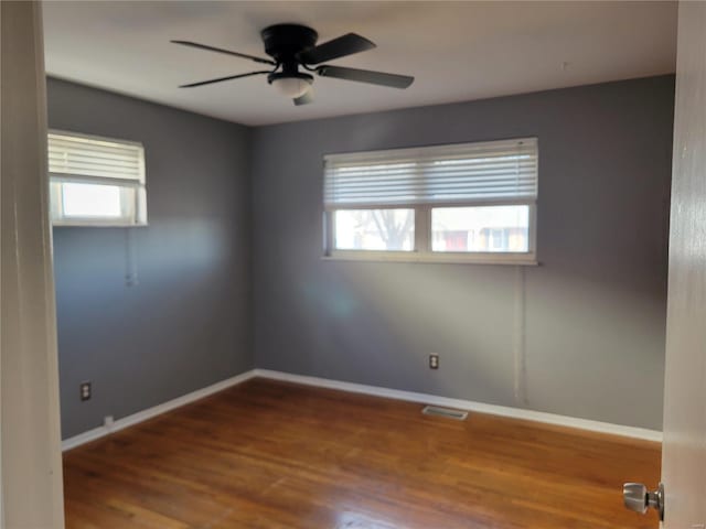 unfurnished room featuring hardwood / wood-style flooring and ceiling fan