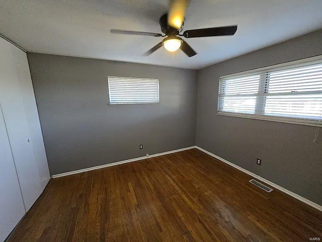 empty room featuring dark hardwood / wood-style floors and ceiling fan