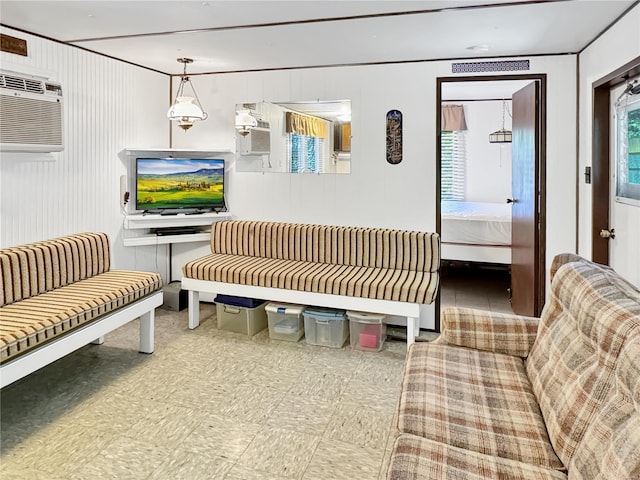 living room featuring wooden walls and a wall unit AC