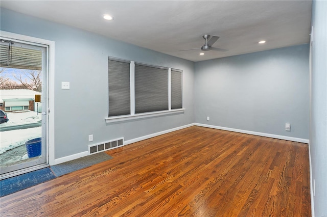 spare room with wood-type flooring and ceiling fan