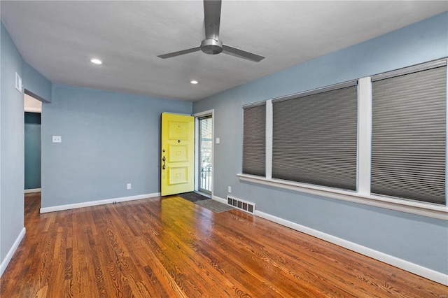 unfurnished room with ceiling fan and dark hardwood / wood-style floors