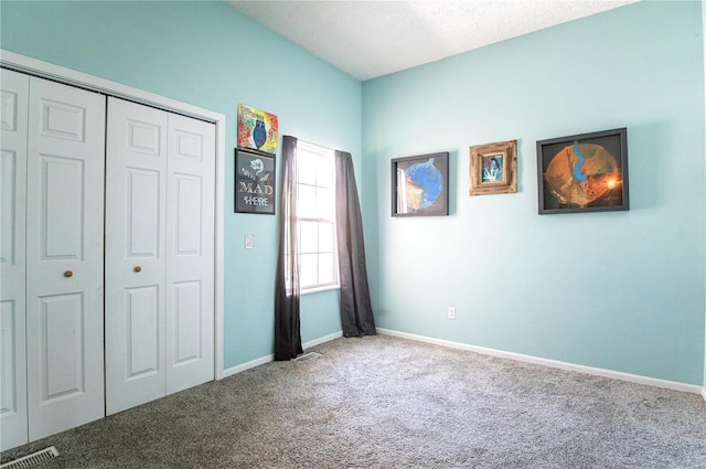 unfurnished bedroom featuring a closet and carpet flooring