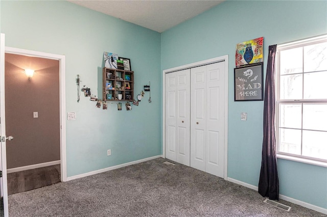 unfurnished bedroom featuring a closet and carpet floors