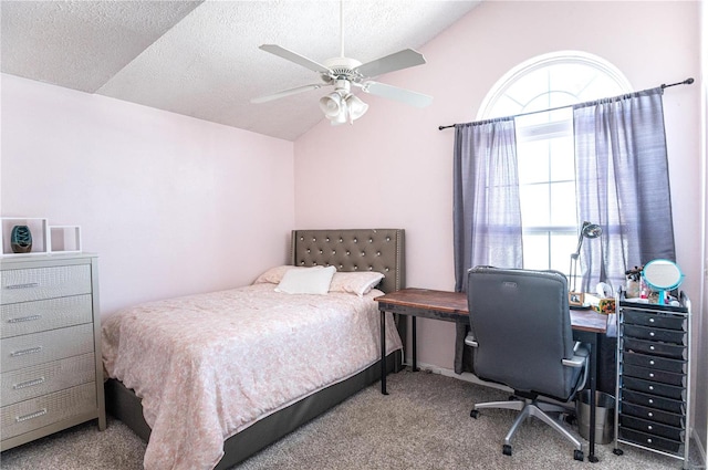 bedroom with lofted ceiling, a textured ceiling, ceiling fan, and carpet floors