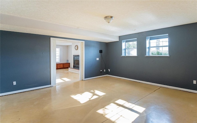 unfurnished room with a textured ceiling