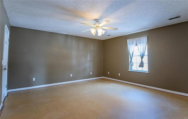 empty room featuring a textured ceiling, concrete floors, and ceiling fan