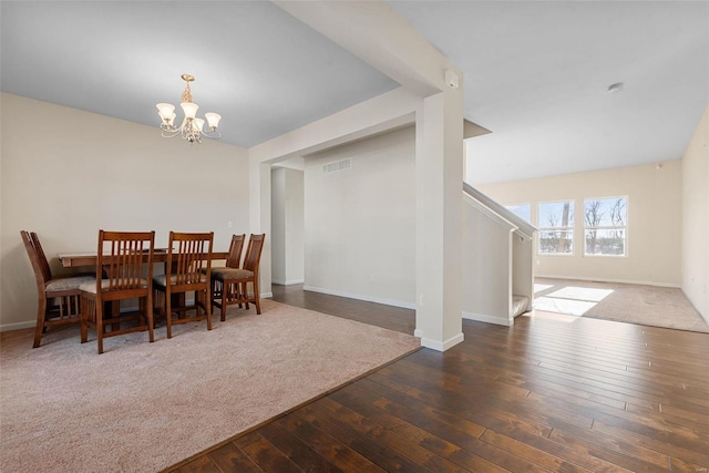 dining space with an inviting chandelier and dark hardwood / wood-style floors