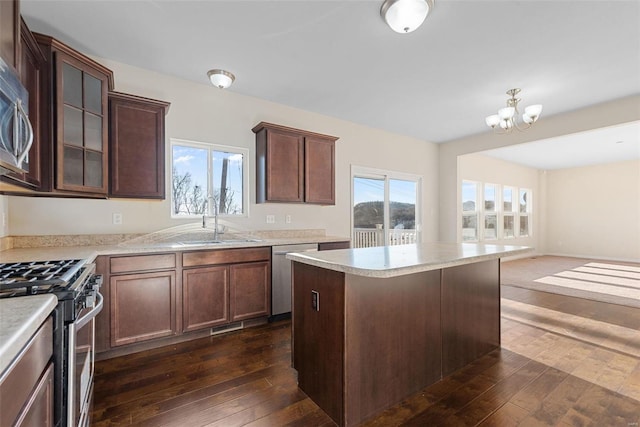 kitchen featuring dark brown cabinetry, sink, stainless steel appliances, and dark hardwood / wood-style floors