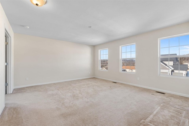 unfurnished room with light colored carpet