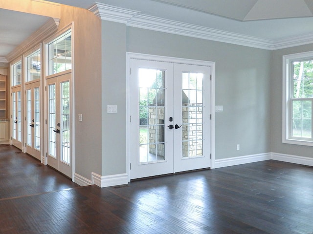 doorway with dark hardwood / wood-style flooring, ornamental molding, and french doors