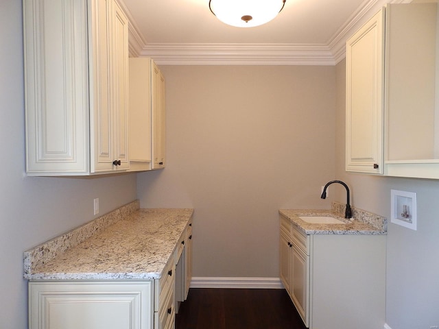 kitchen featuring sink, dark wood-type flooring, ornamental molding, light stone countertops, and white cabinets