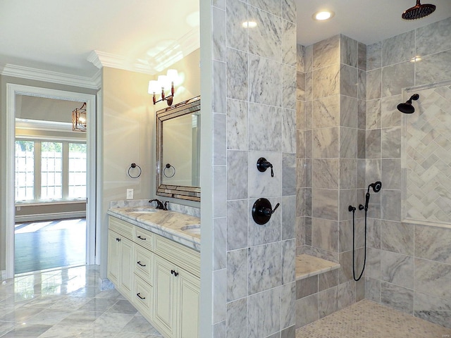 bathroom with crown molding, vanity, and a tile shower