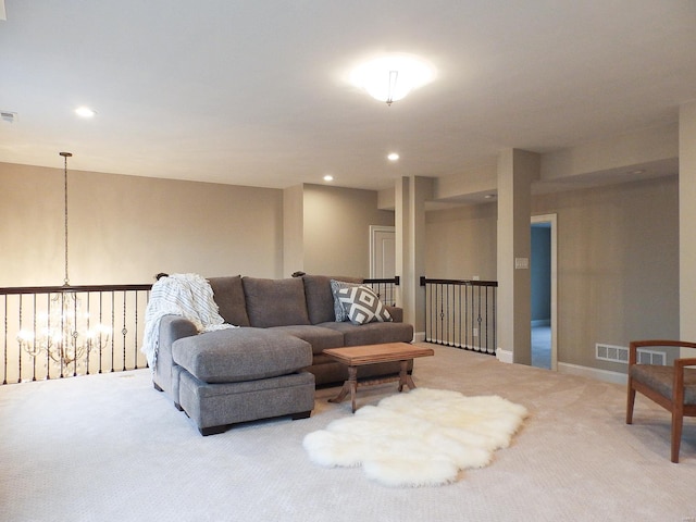 living room with carpet floors and a notable chandelier