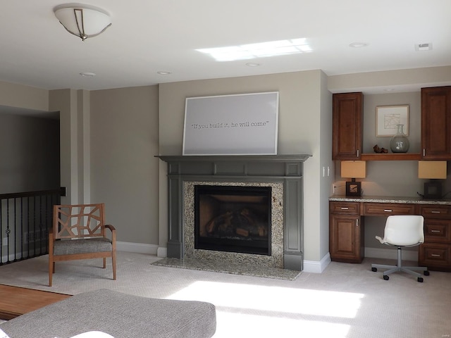 living room with a high end fireplace and light colored carpet