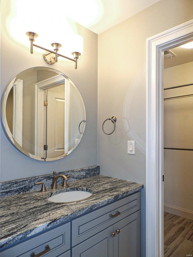 bathroom with vanity and wood-type flooring