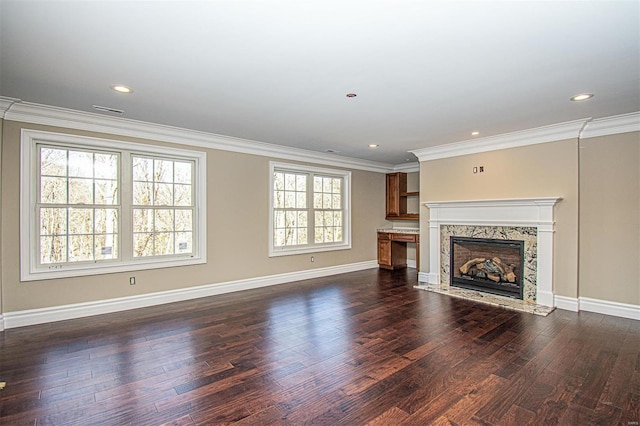 unfurnished living room featuring crown molding, a fireplace, and dark hardwood / wood-style flooring