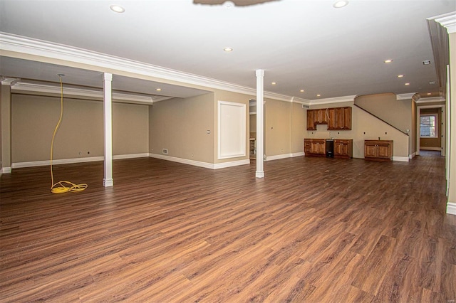 basement with ornamental molding and dark hardwood / wood-style flooring