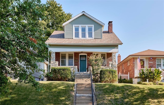 view of front facade with a porch and a front lawn