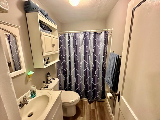 bathroom with hardwood / wood-style floors, vanity, and toilet