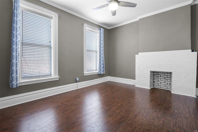 unfurnished living room with dark hardwood / wood-style flooring, crown molding, a brick fireplace, and ceiling fan