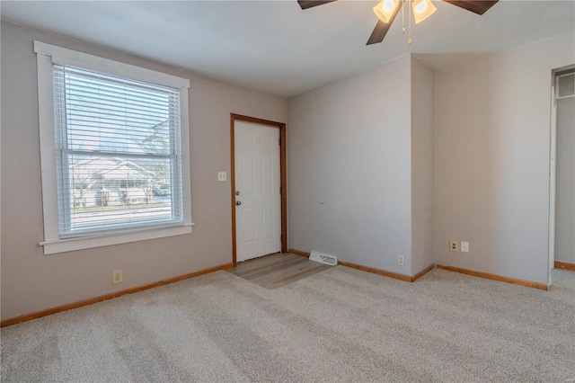 carpeted empty room with ceiling fan