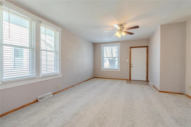 carpeted empty room with ceiling fan