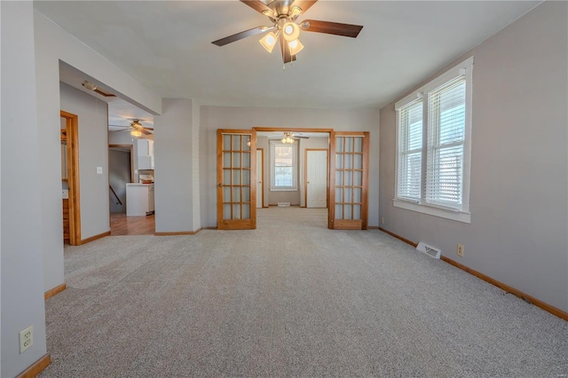 carpeted empty room with french doors