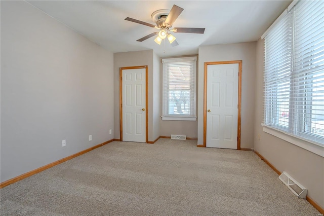 unfurnished bedroom featuring light colored carpet and ceiling fan