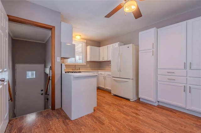 kitchen featuring ceiling fan, white fridge, white cabinets, and light hardwood / wood-style floors