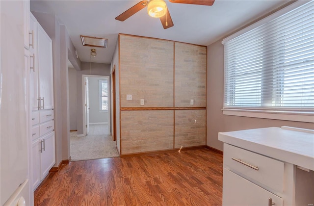 interior space with light hardwood / wood-style flooring and ceiling fan