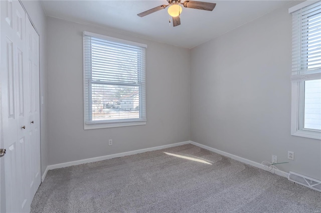 empty room featuring ceiling fan and carpet flooring