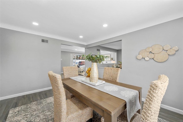 dining area with dark hardwood / wood-style flooring