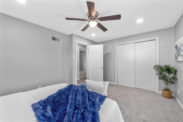 carpeted bedroom featuring a closet and ceiling fan