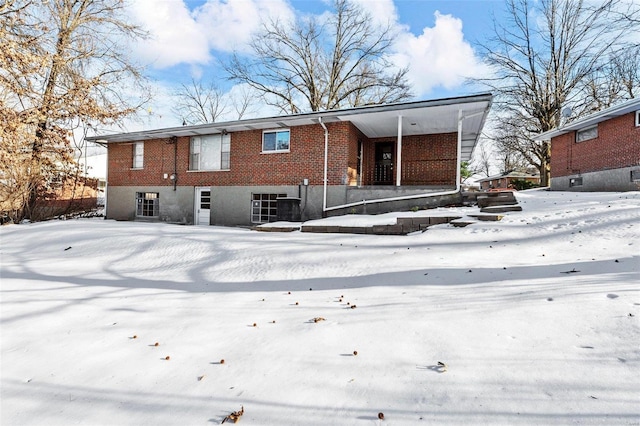 view of snow covered rear of property