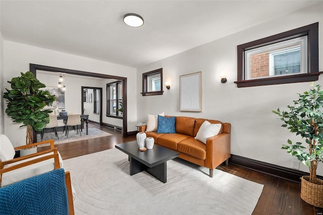 living room featuring a healthy amount of sunlight and dark hardwood / wood-style floors