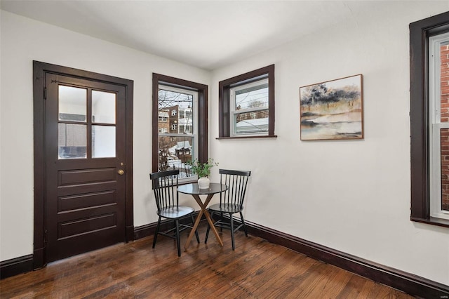 dining space with dark hardwood / wood-style flooring