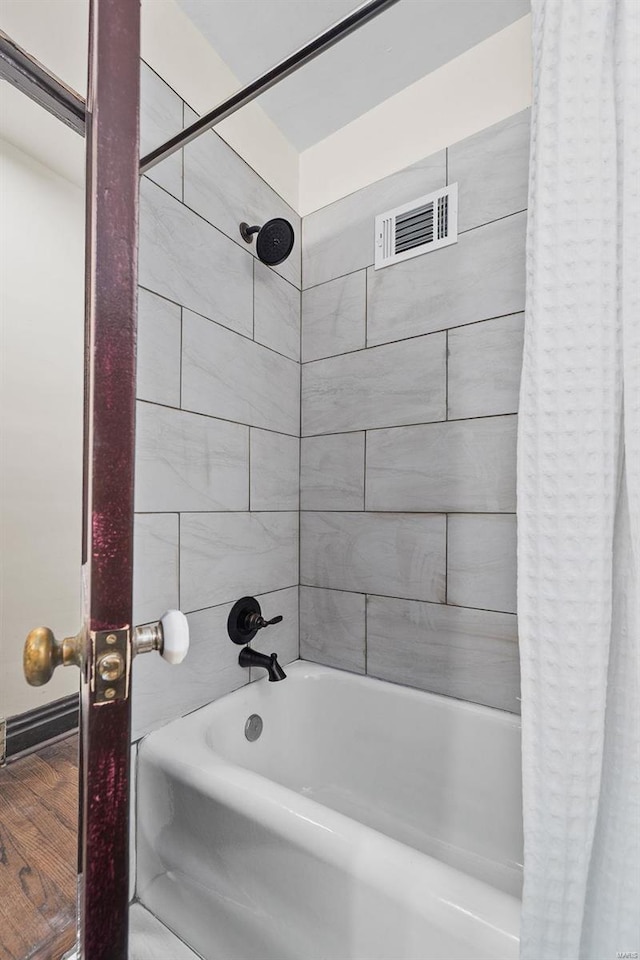 bathroom with shower / bathtub combination with curtain