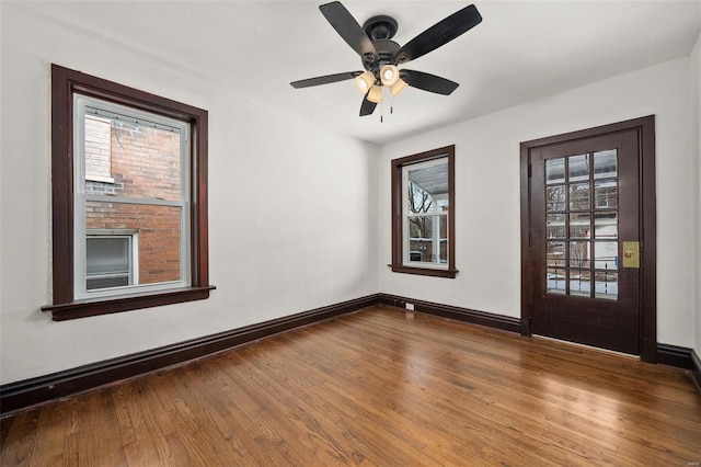 empty room with hardwood / wood-style flooring and ceiling fan