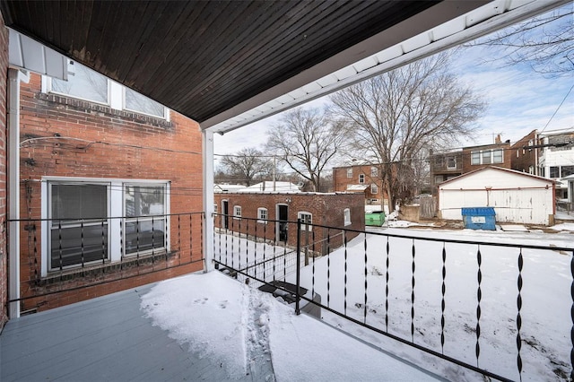 view of snow covered back of property