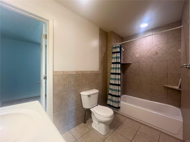 full bathroom featuring tile walls, toilet, tile patterned floors, and shower / bath combo